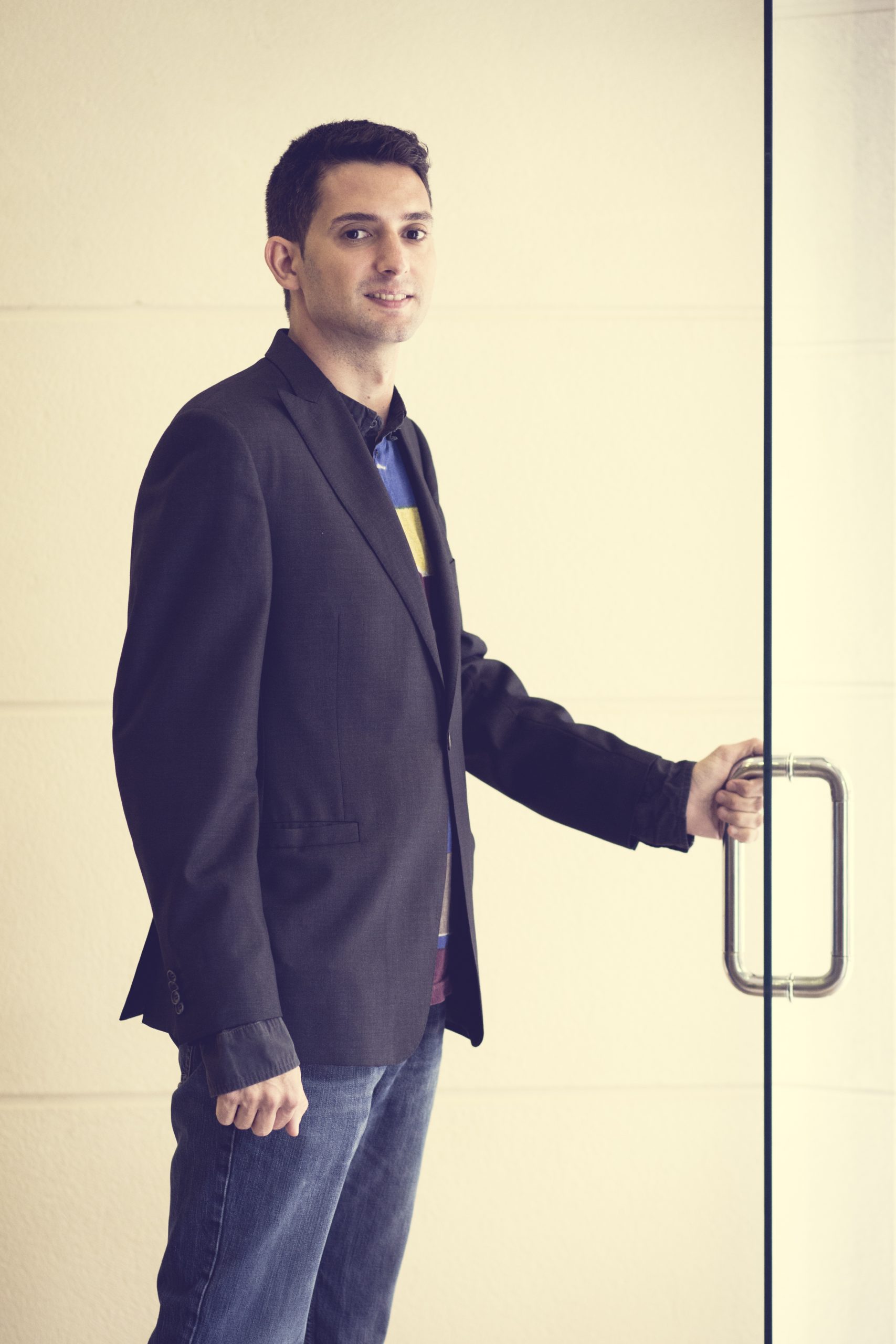 Tomás Mayordomo Feliu, Instructor titulado de seguridad alimentaria de manipuladordealimentos.online, abriendo una puerta de cristal de su centro de formación.